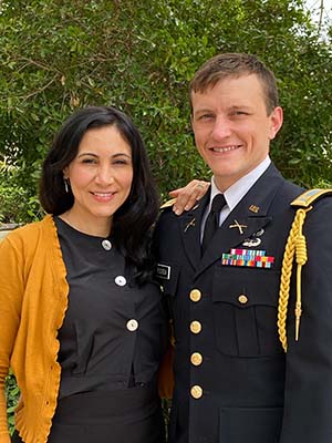 Y-12er Rose R. stands with her husband, Major Brennan R., at his promotion ceremony. 