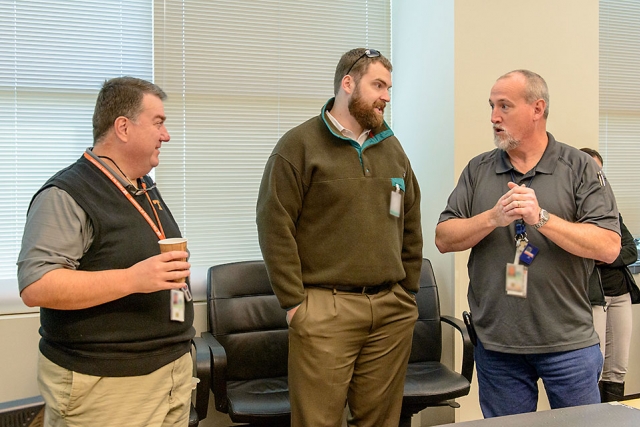 UT’s Howard Hall and John Gill and Jeff Knott (Y-12) discuss battle board strategies.