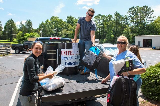 Y-12 employees unload school supplies donated to ADFAC. 
