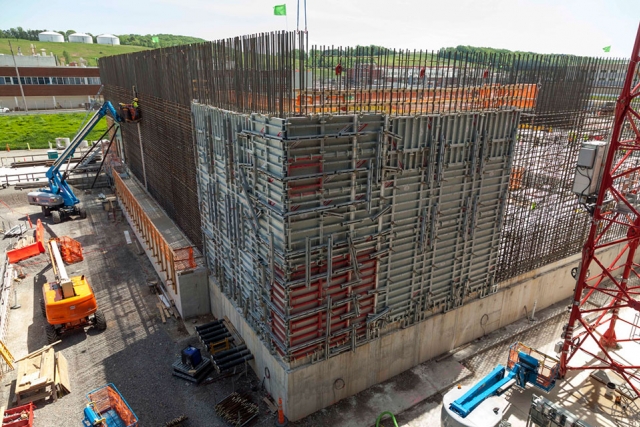 The first vertical wall for the Main Process Building (MPB) has been placed. The wall is 27 feet tall and required 196 cubic yards of concrete.