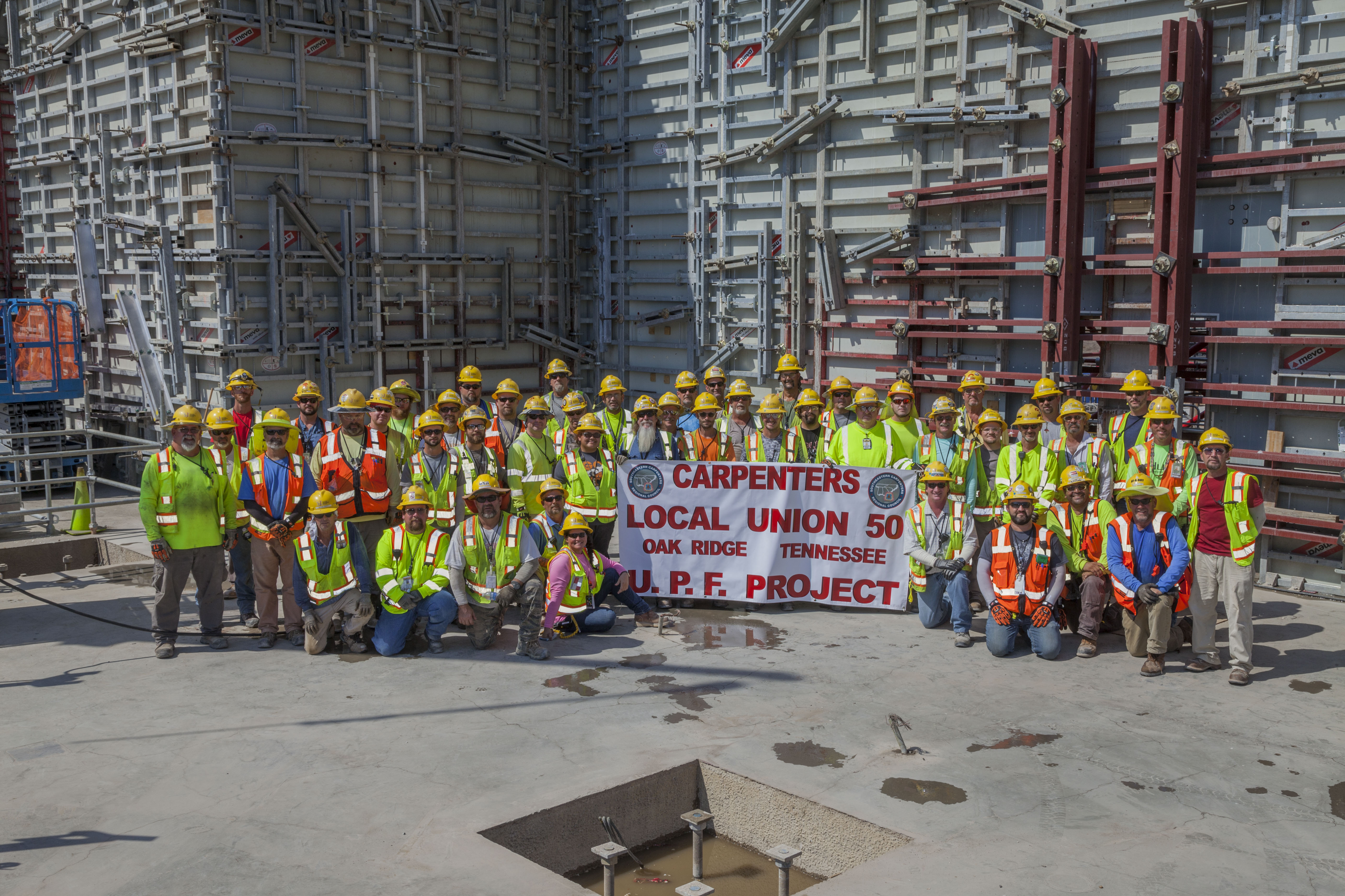 Uranium Processing Facility carpenters celebrate completion of Main Processing Building first level walls.