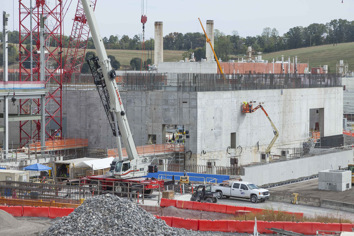 Members of the skilled craft workforce conducts finish work on the Uranium Processing Facility Main Process Building first level walls. 