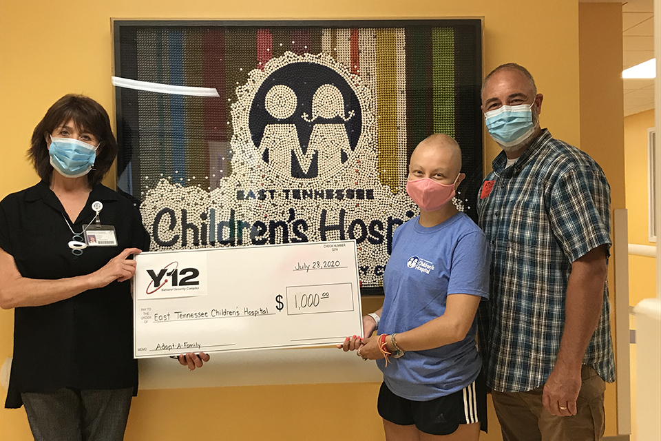 Y-12’s John Fellers and his daughter, Josie, present a check to Cheryl Allmon, director of Volunteer Services and Programs at ETCH