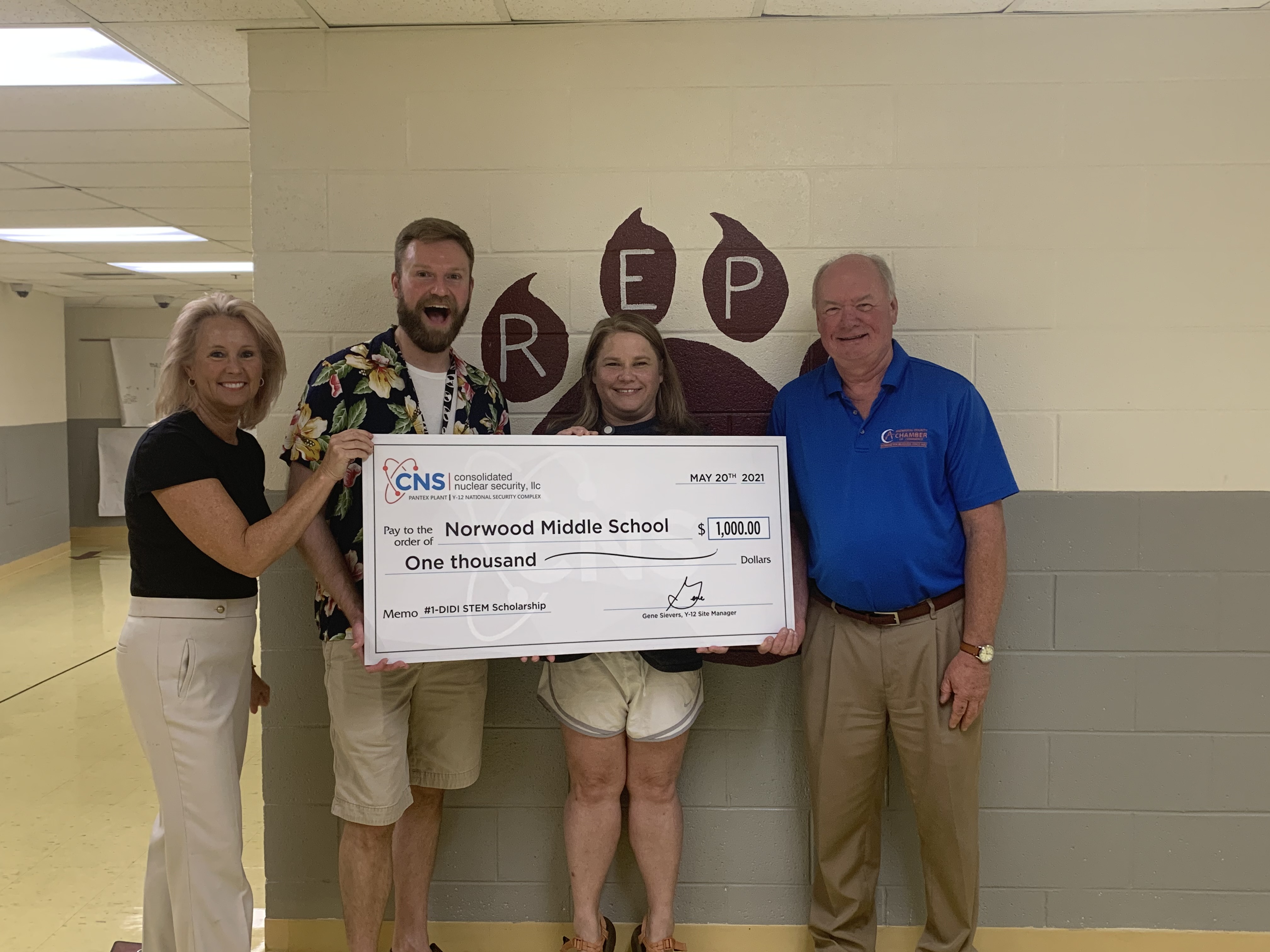Kristin Waldschlager (left), CNS educational outreach specialist, presents a check to Norwood Middle School 