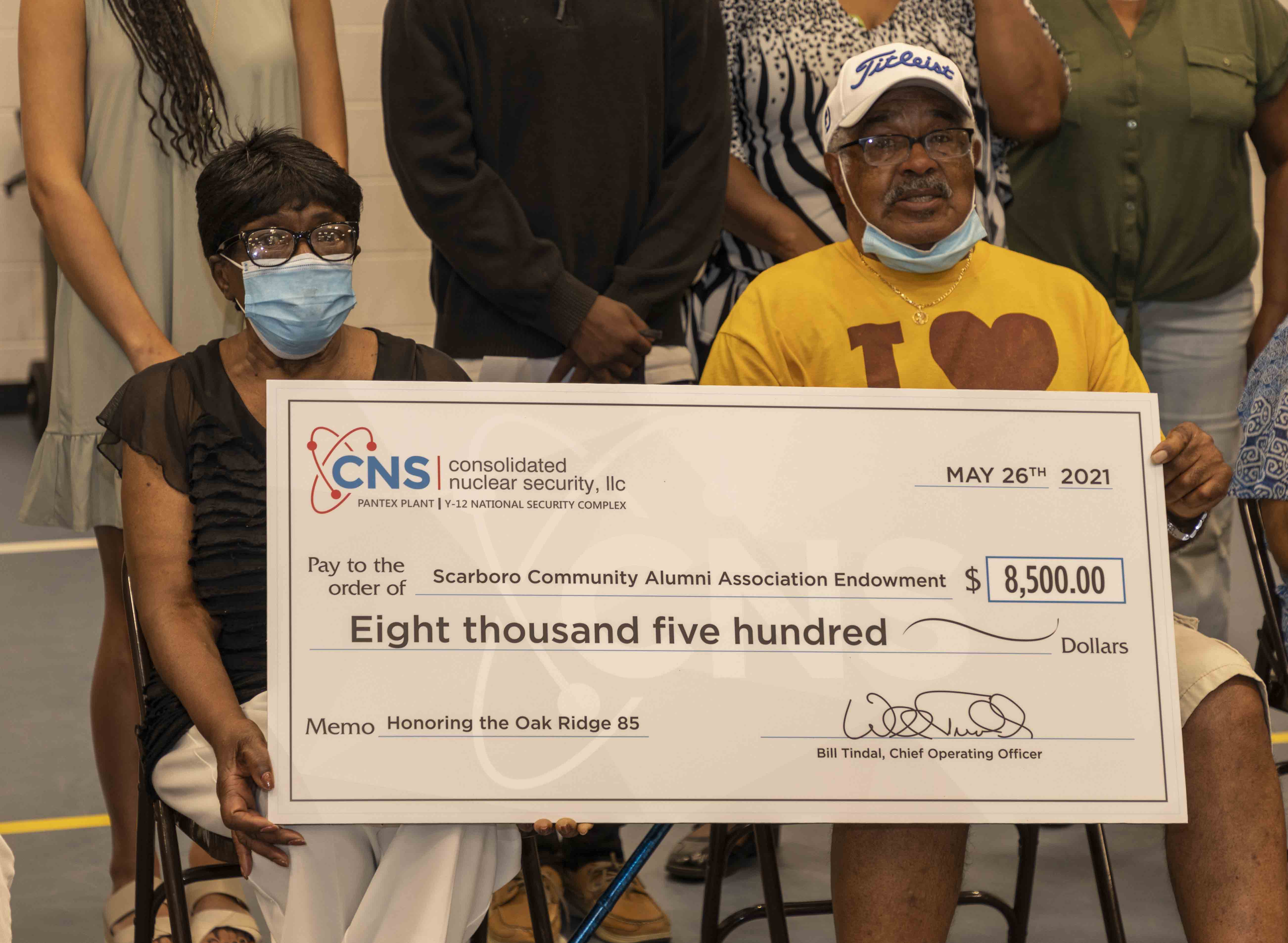 Dorothy Kirk Lewis and L. C. Gipson, members of the Oak Ridge 85, hold the check representing the $8,500 donation from Consolidated Nuclear Security given in their honor.