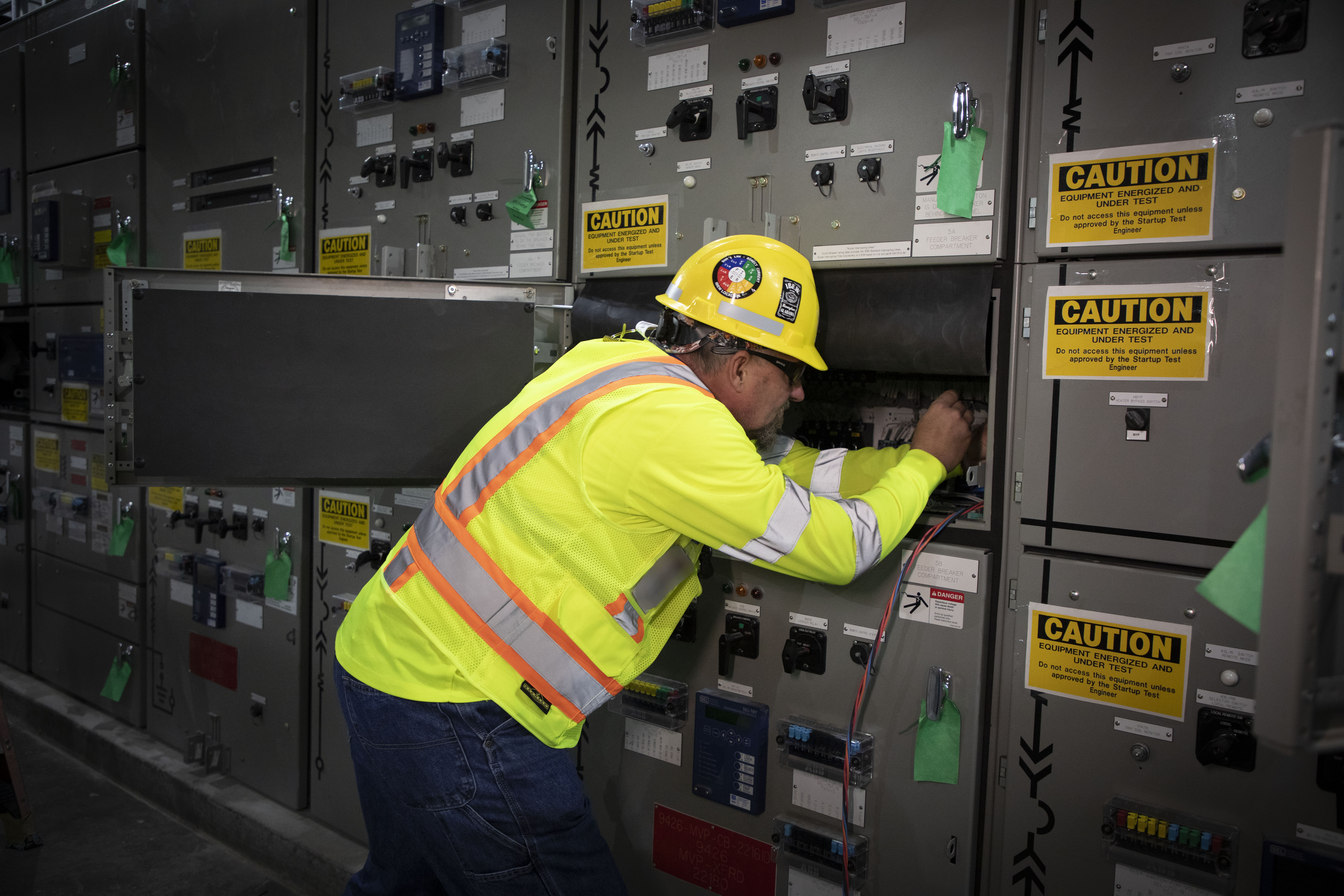 UPF Electrician inspects wiring in the 13.8kV switchgear 