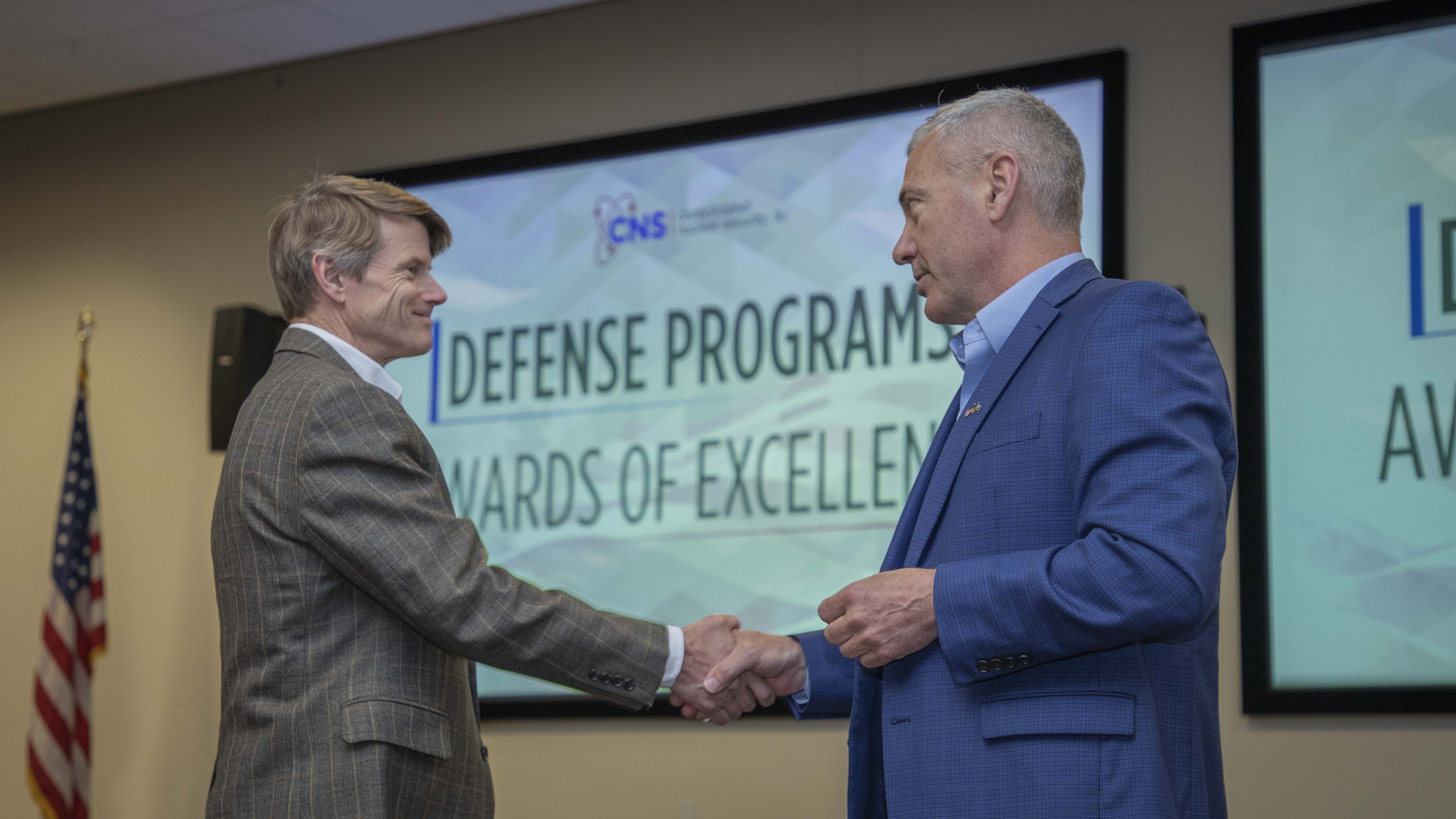 Marvin Adams (left), National Nuclear Security Administration (NNSA) Deputy Administrator for Defense Programs, shakes hands with Y-12 Site Manager Gene Sievers 