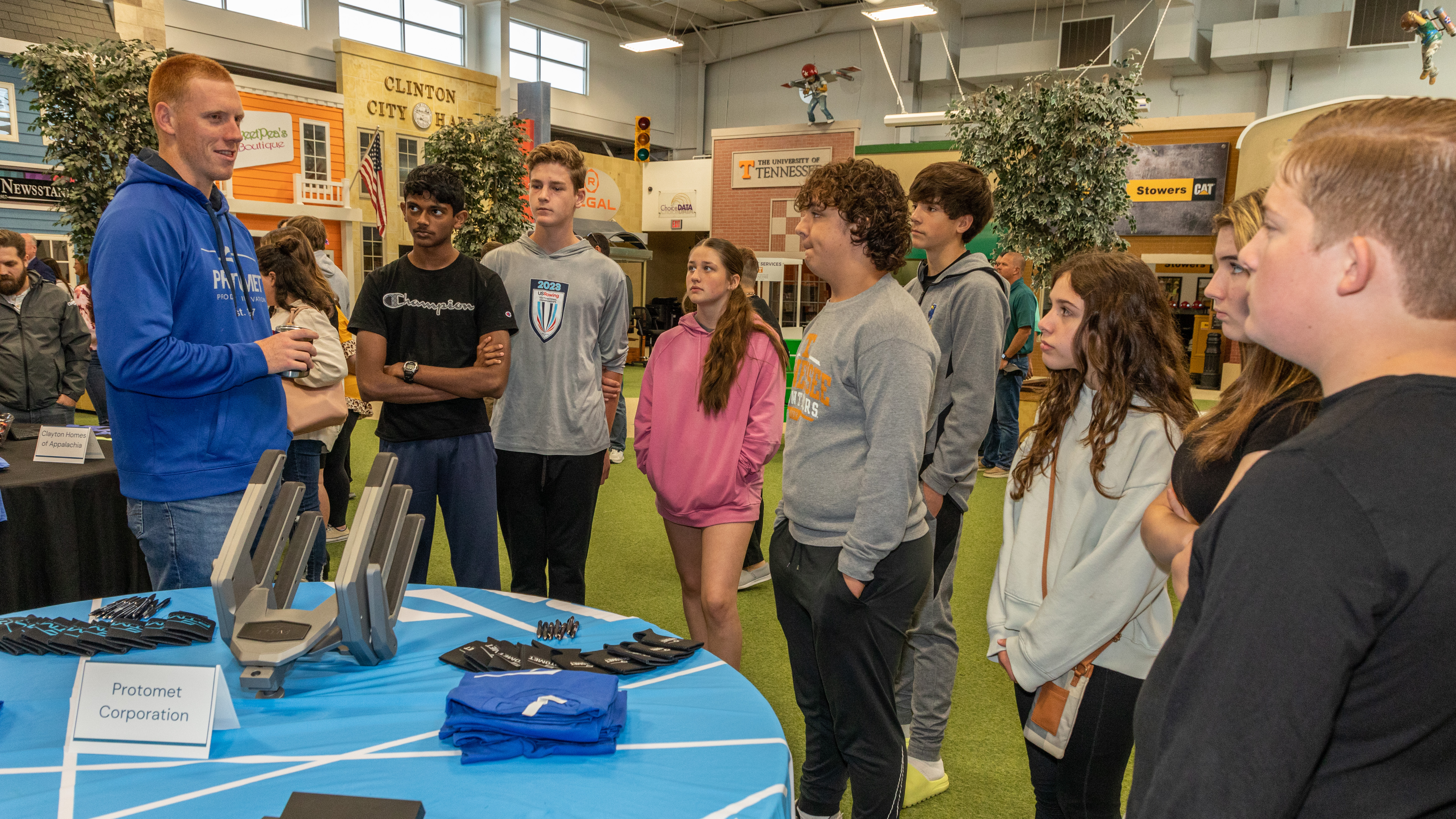 Protomet Corporation’s industry representative talks with members of the Clinton Middle School team. 