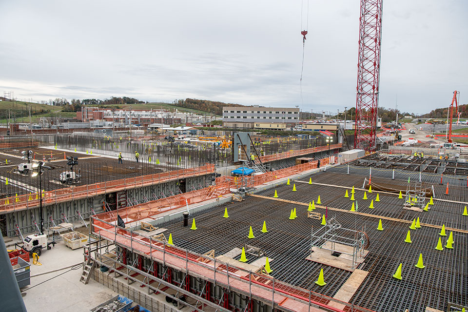 Rebar installation continued on the Salvage and Accountability Building, right, in November, while rebar installation and concrete placement continued on the Main Process Building, left.