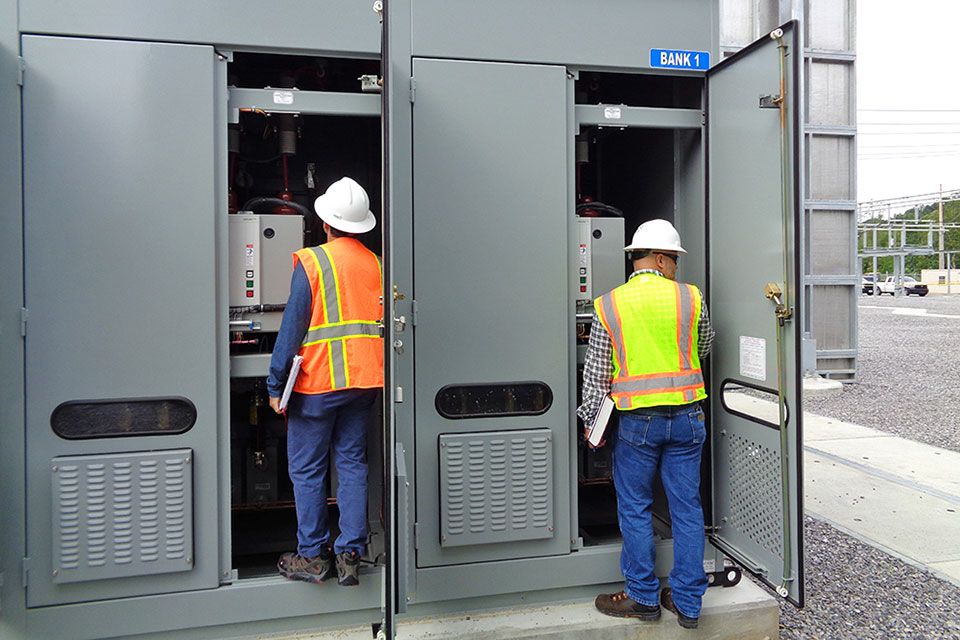 One of two capacitor banks for the Pine Ridge Substation is inspected during a turnover walkdown. The capacitor bank is designed to maintain a stable power supply for the Uranium Processing Facility and the Y-12 National Security Complex.