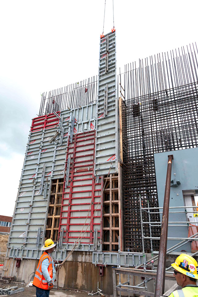 Forms are installed on the outside of a rebar wall curtain at the Main Process Building (MPB). Once inside and outside forms are installed, concrete is placed to construct the outside wall of the MPB. 