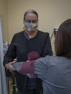 Y-12 nurse Denise Howard checks an employee’s blood pressure.