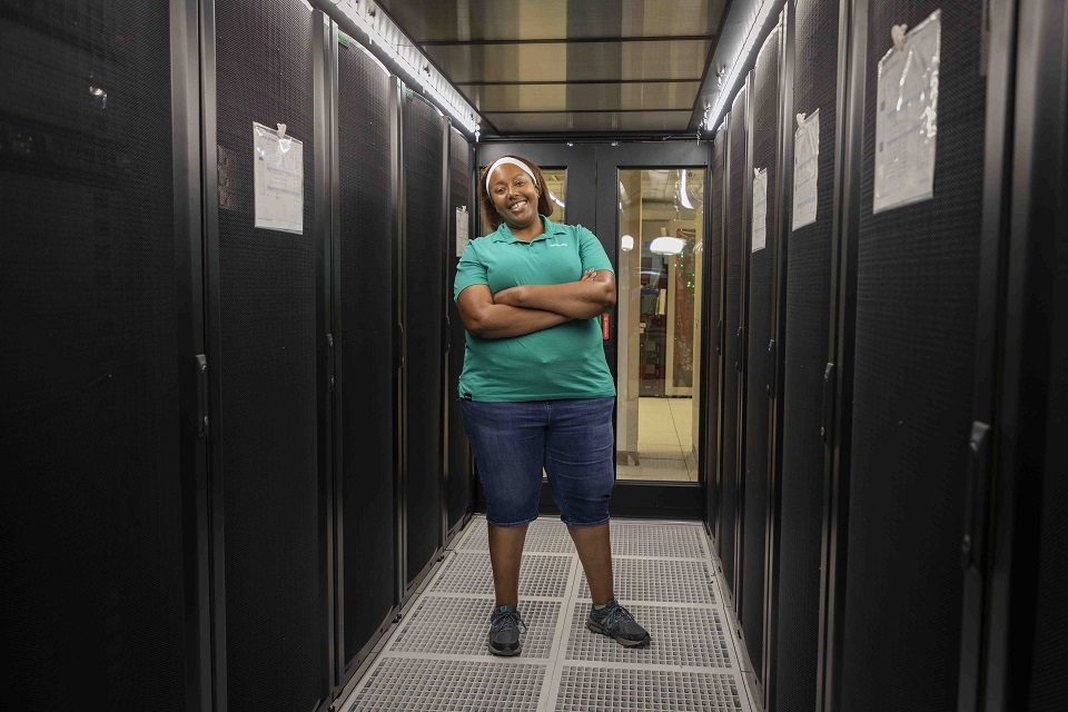 Kami Bush, IT Systems administrator, stands among servers in Y-12’s data center