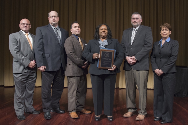 Award was presented by (far left) Tim Unruh, DOE Deputy Assistant Secretary for Renewable Power and (far right) Leslie Nicholls, DOE, Director, Acting Federal Energy and Water Management Program. Accepting the award for the team (center left to right) Robert Hickman, JCI System Engineer, Leon Archuleta, NNSA Contracting Officer Specialist, Anna Beard, Federal Project Director, NPO Contracting Officer Representative, Jason Pool, JCI Performance Assurance Engineer 