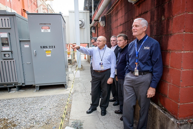 NPO Program Manager David Wall points out infrastructure upgrades to NNSA Uranium Program Manager Tim Driscoll, front, during a recent tour of Y‑12’s Building 9995.