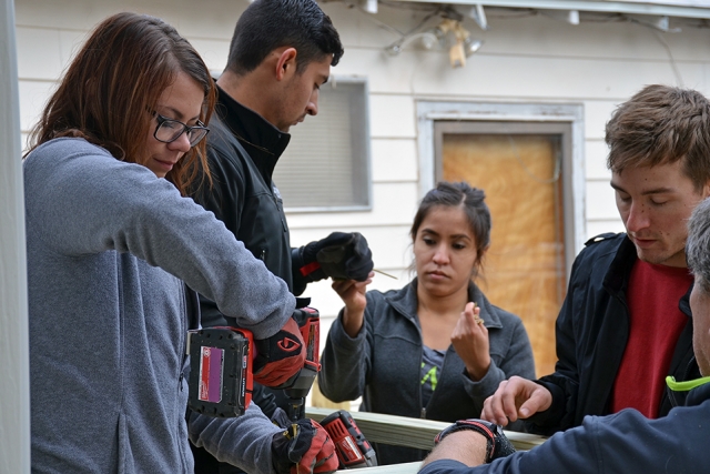 Members of the Pantex Outreach and Leadership Organization build a handicap accessible ramp for a homeowner as part of the Texas Ramp Project.