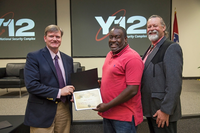 Y-12 Site Manager Bill Tindal (left) and NPO Manager Geoff Beausoleil (right) congratulate electrician graduate Andre Blocker on successful completion of the Y-12 Apprentice Program.
