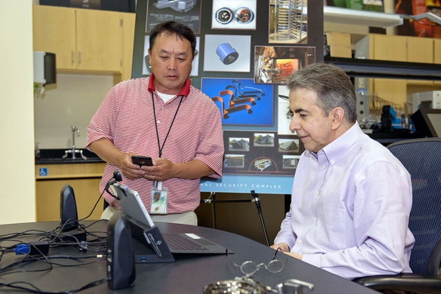 Kia Moua (left) and Lee Bzorgi prepare for a video teleconference with aspiring roboticists at Northern Kentucky University.