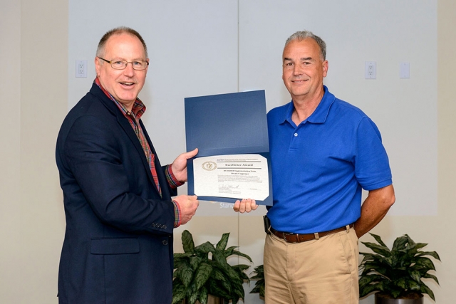 Dwain Coppenger (right) accepts the NNSA Excellence Award from James McConnell.
