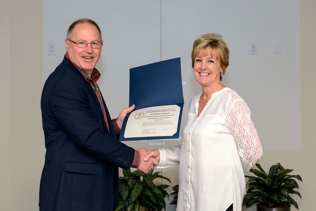 Jane Nations accepts one of her two NNSA Excellence Awards from James McConnell associate administrator for Safety, Infrastructure and Operations.