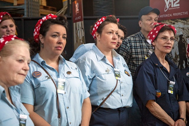 Women dressed as the World War II icon Rosie the Riveter tour Y‑12 during the Secret City Festival.