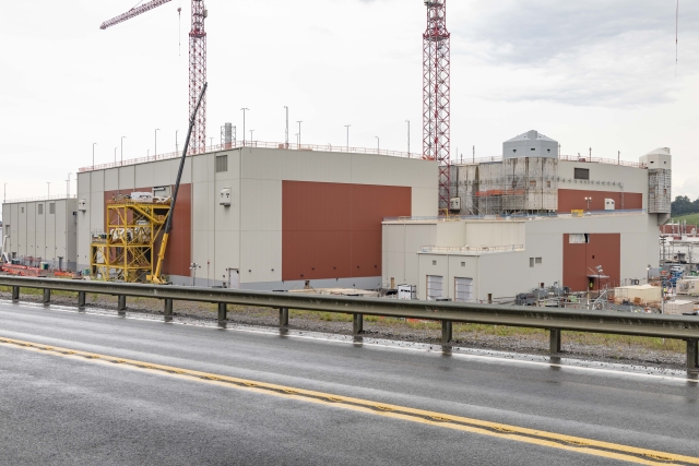 UPF construction site showing Main Process Building siding progress August-2022