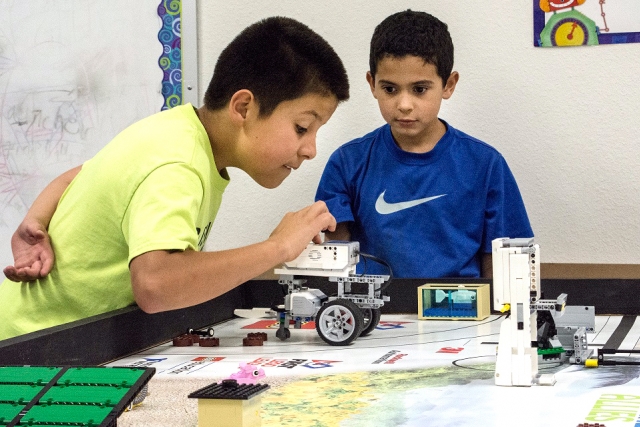 Bushland Independent School District robotics team members take turns testing their robots on the FIRST LEGO League practice field.