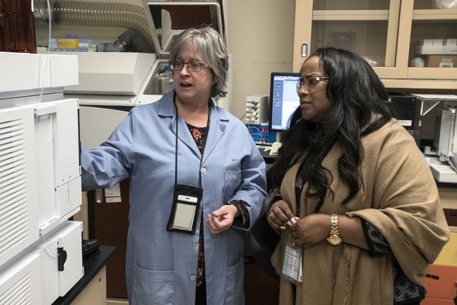Stephanie Steelman (left) shows Nicole Nelson-Jean, NNSA Governance Committee chair and Savannah River Site manager equipment at the Pantex chemistry lab.