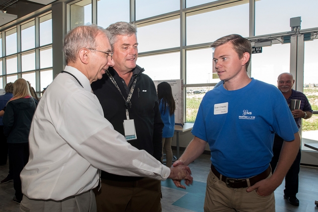 Evan from @school (right) talks with Morgan Smith (left) and Mike Beck at the Pantex Intern Expo.