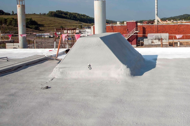 Significant prep work was required to seal and frame penetrations at Building Alpha‑5, but the new commercial foam roofing material will result in a significant reduction in facility flooding and water leakage.