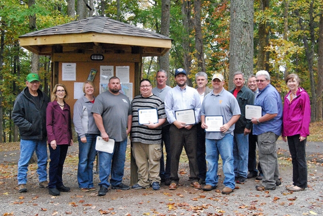 Members of the Y-12 journeyman machinist apprentice class gather at Norris Dam State Park to celebrate completing the classroom portion of their training. (Photo courtesy of Christine Jessel Grider/PSTCC.) 
