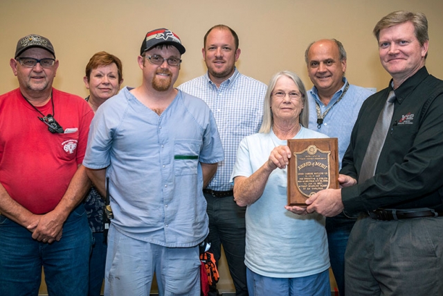 Construction and Projects Management received an award active participation in safety and injury-free work. Monica Lewis, Construction, accepts the award on behalf of the organization from Y-12 Site Manager Bill Tindal.