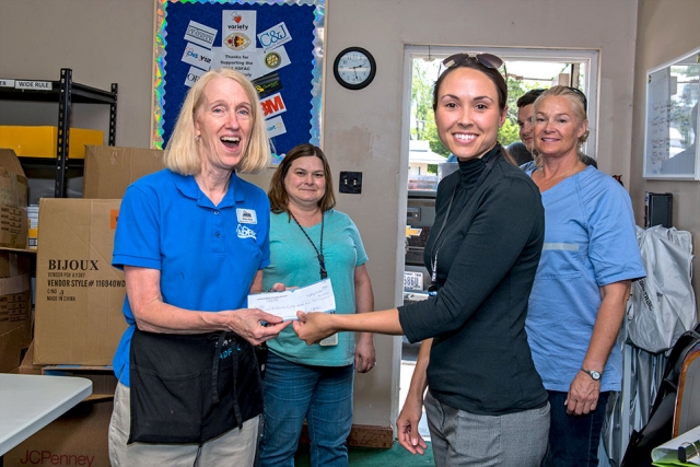 Anita Hazlewood, Y-12’s United Way chairperson, presents a check to ADFAC in support of the agency’s annual school supply drive. 