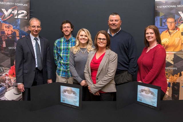 Consolidated Nuclear Security, LLC President and CEO Morgan Smith (left) joins CEO Cindy Hatfield (front center) and employees of Hatfield Constructions after signing a mentor-protégé agreement. 