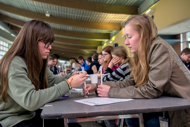 Two ORHS students work together to create a weight-bearing suspended bucket tower as part of EWeek. Almost 1,000 students participated in activities throughout the day. 