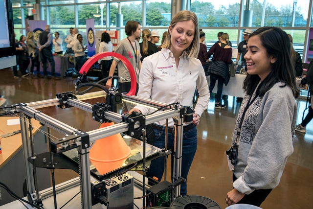 At the Y-12 National Security Complex’s Introduce a Girl to Engineering event last week, Téa Phillips, left, demonstrates a 3D printer to Lesly, an Oak Ridge High School senior. “I like talking to the girls, getting them interested in engineering and Y-12,” said Phillips, a mechanical engineer and recent Y-12 hire. “I’ve always wanted to work on something important, something where I can make a difference. I’ve found that work at Y-12, and I’m sharing that message with these girls.”