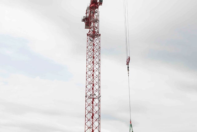 The west tower crane at the Uranium Processing Facility relocates a manlift onto the Salvage and Accountability Building foundation.