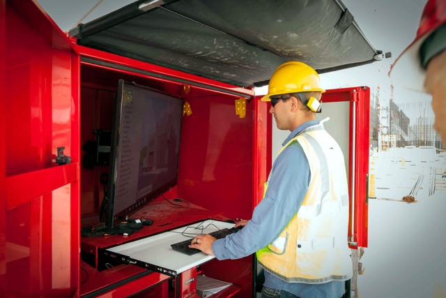 A Uranium Processing Facility (UPF) civil field engineer uses a computer located on the UPF construction site to access 3-D models of the buildings and work packages.