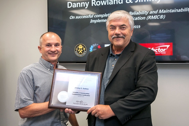 UT’s Dr. Klaus Blache, right, congratulates Y-12’s Jimmy Dalton, an outside machinist, on earning his Reliability and Maintainability Implementation Certification.