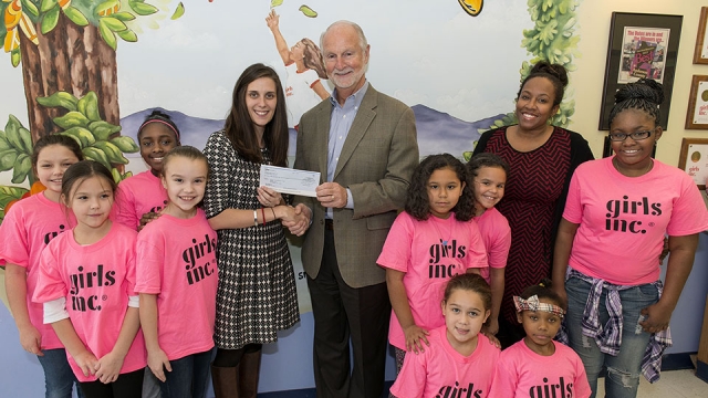 Girls Inc. Executive Director Rhoni Basden (left) accepts a donation from Consolidated Nuclear Security, LLC (CNS) Vice President for Operations Support Darrell Graddy (center) with CNS employee and Girls Inc. board member, Sheryl Houston (right). 