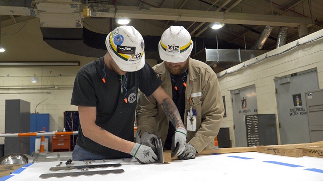 Construction employees create stainless steel rake blades to be used at Oak Ridge’s Friendship Bell Pavilion.