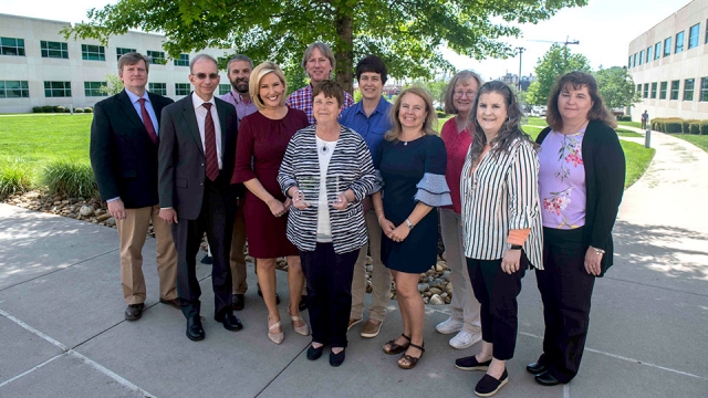 Alma Carter (center) is surrounded by her Y-12 work family and guest speaker Kristin Farley (to the left of Carter).