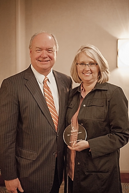 Chamber President Rick Meredith congratulates Waldschlager at the February 9 luncheon.