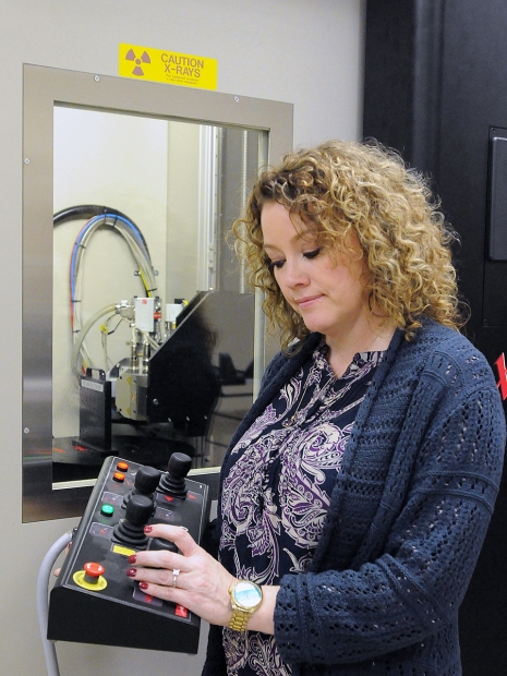 Pantex’s Felicia Bellis uses controls to move a turntable of the microfocus X-ray machine, one of many technologies Pantex technicians use to ensure quality.