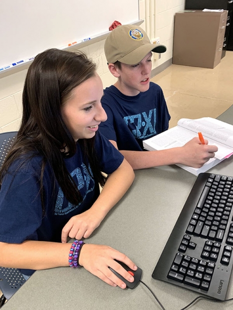 Oak Ridge High School students Elizabeth and Thomas work together on a training scenario to secure a company’s operating system.