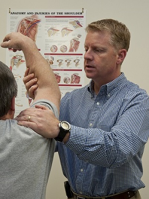 Shoulders are common problem spots for physical therapy patients. Y-12 physical therapist Gary Hall examines the arm of a client.