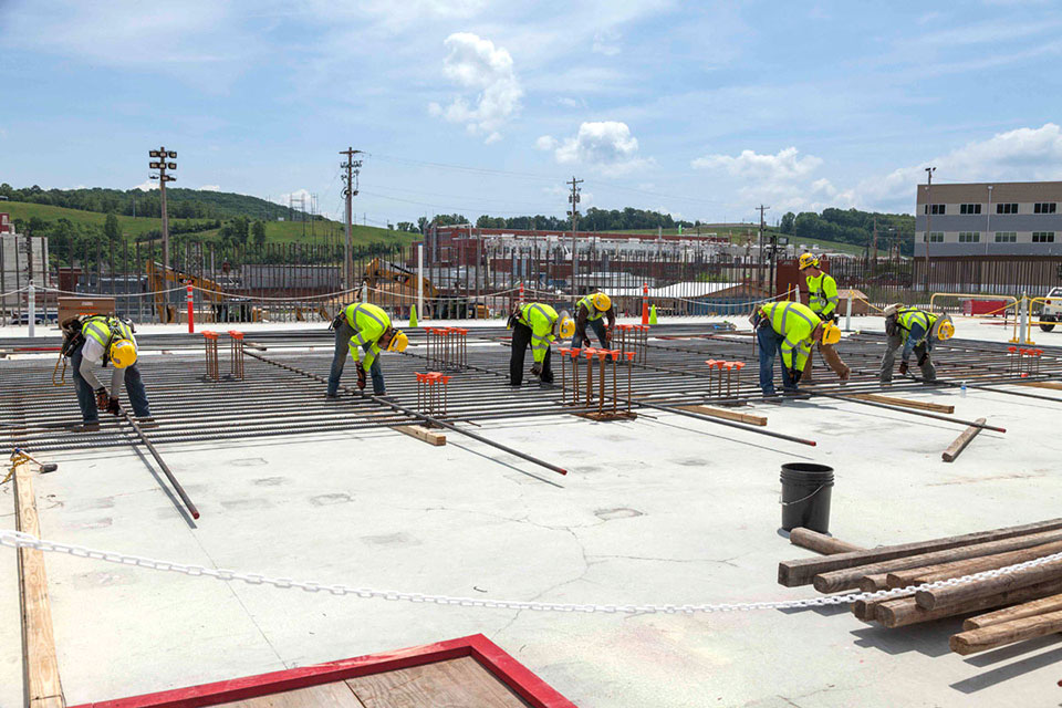 Skilled ironworkers position rebar for a wall curtain at the Main Process Building. 