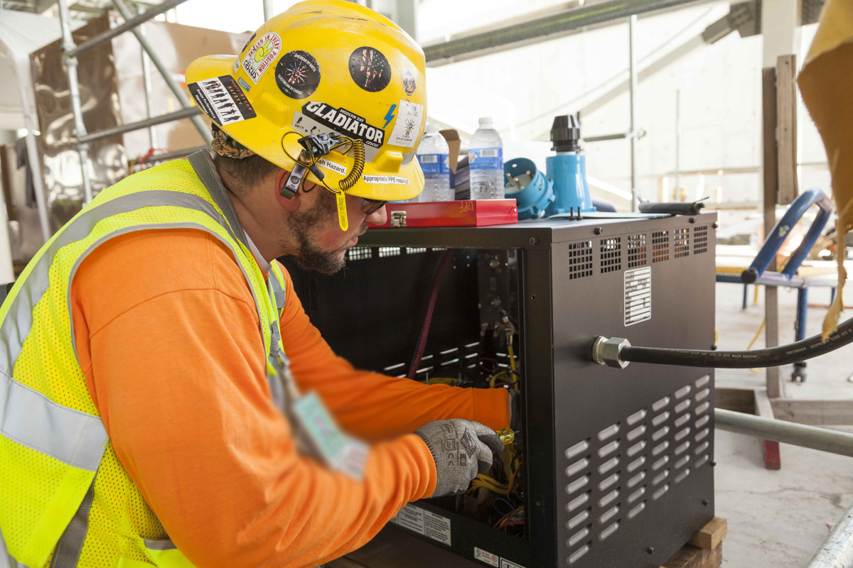 A Uranium Processing Facility (UPF) team member works on the setup of Construction power in the UPF Salvage and Accountability Building.