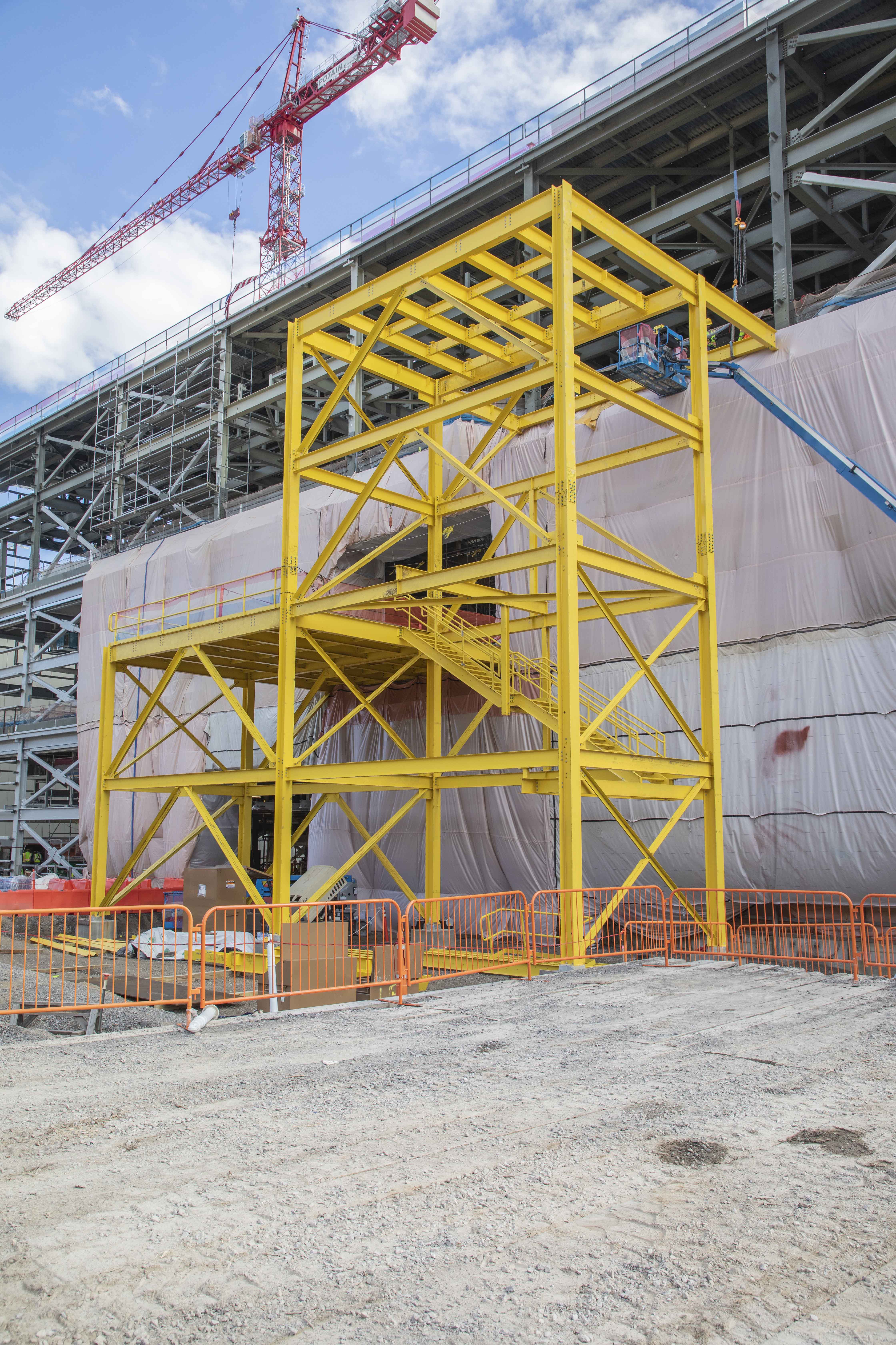 Bright yellow temporary steel was installed on the outside of the Salvage and Accountability Building this month, which will allow large pieces of equipment to enter the facility after siding is installed.