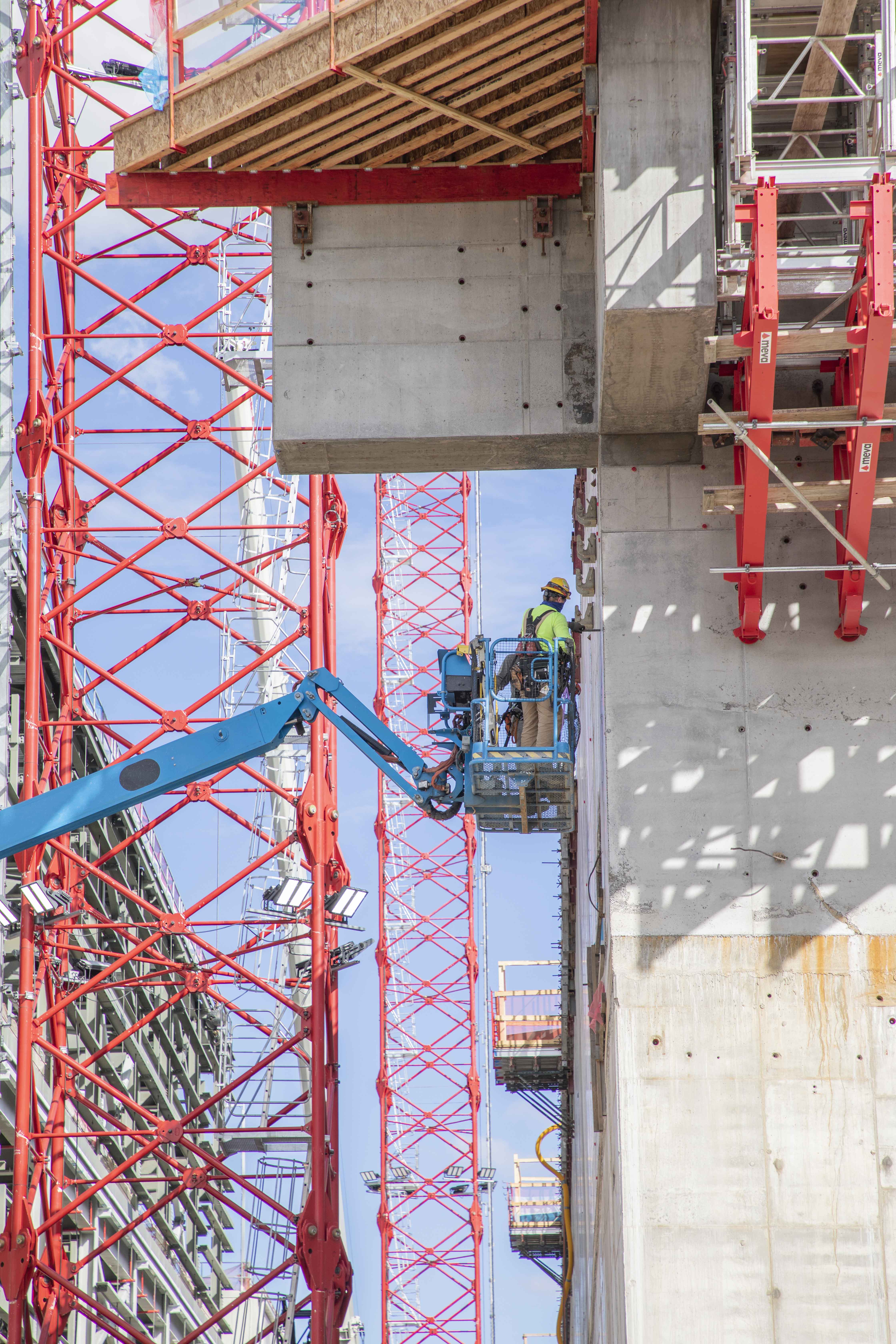 UPF ironworker inspects a second elevation concrete wall on the Main Process Building.
